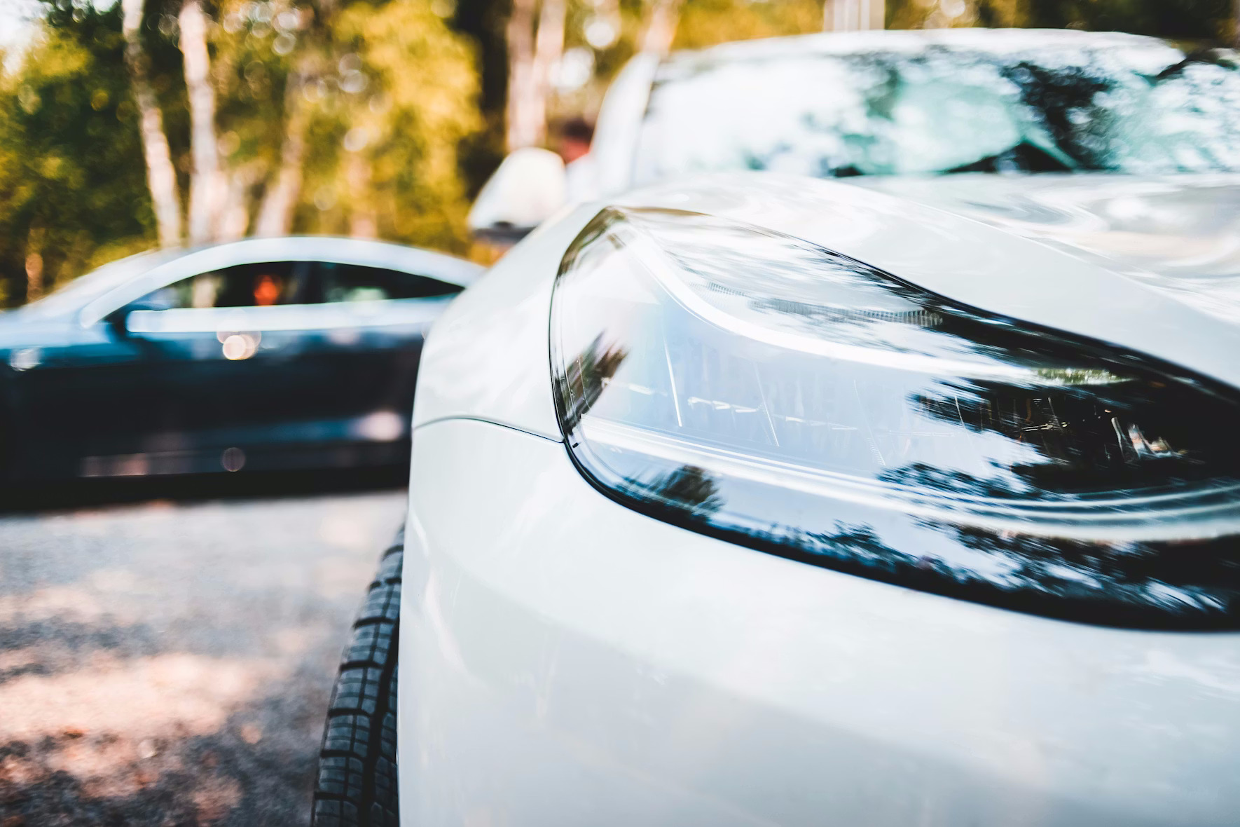 Professional woman standing in front of cars